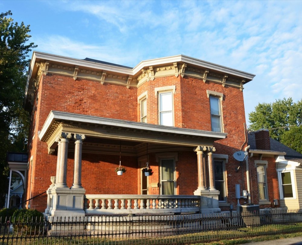 Historic brick home with a covered front porch