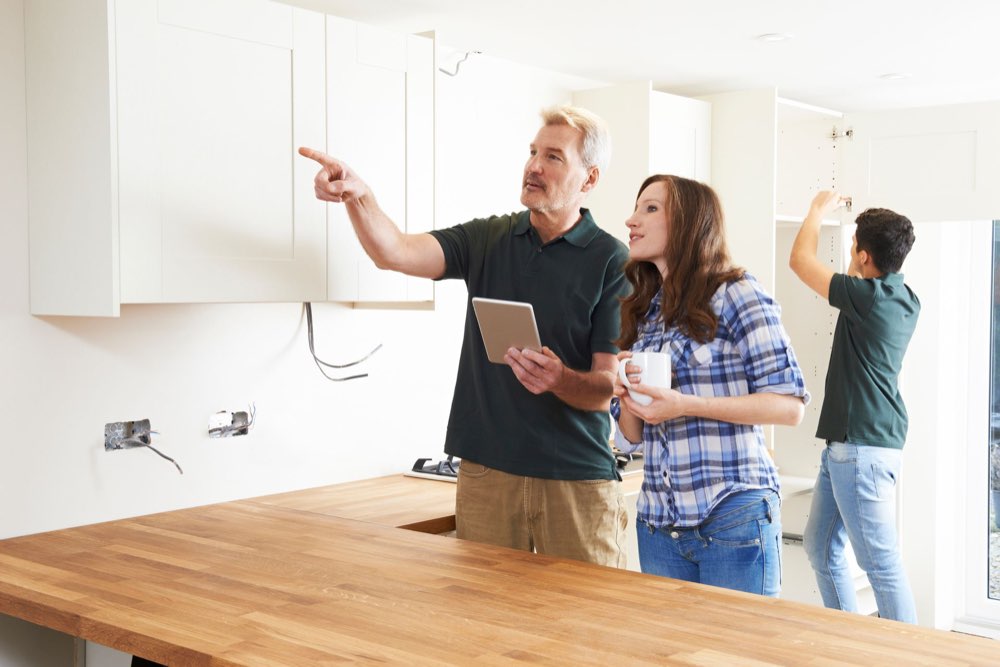 Home inspector walking new home buyers through a kitchen in Morgantown, WV